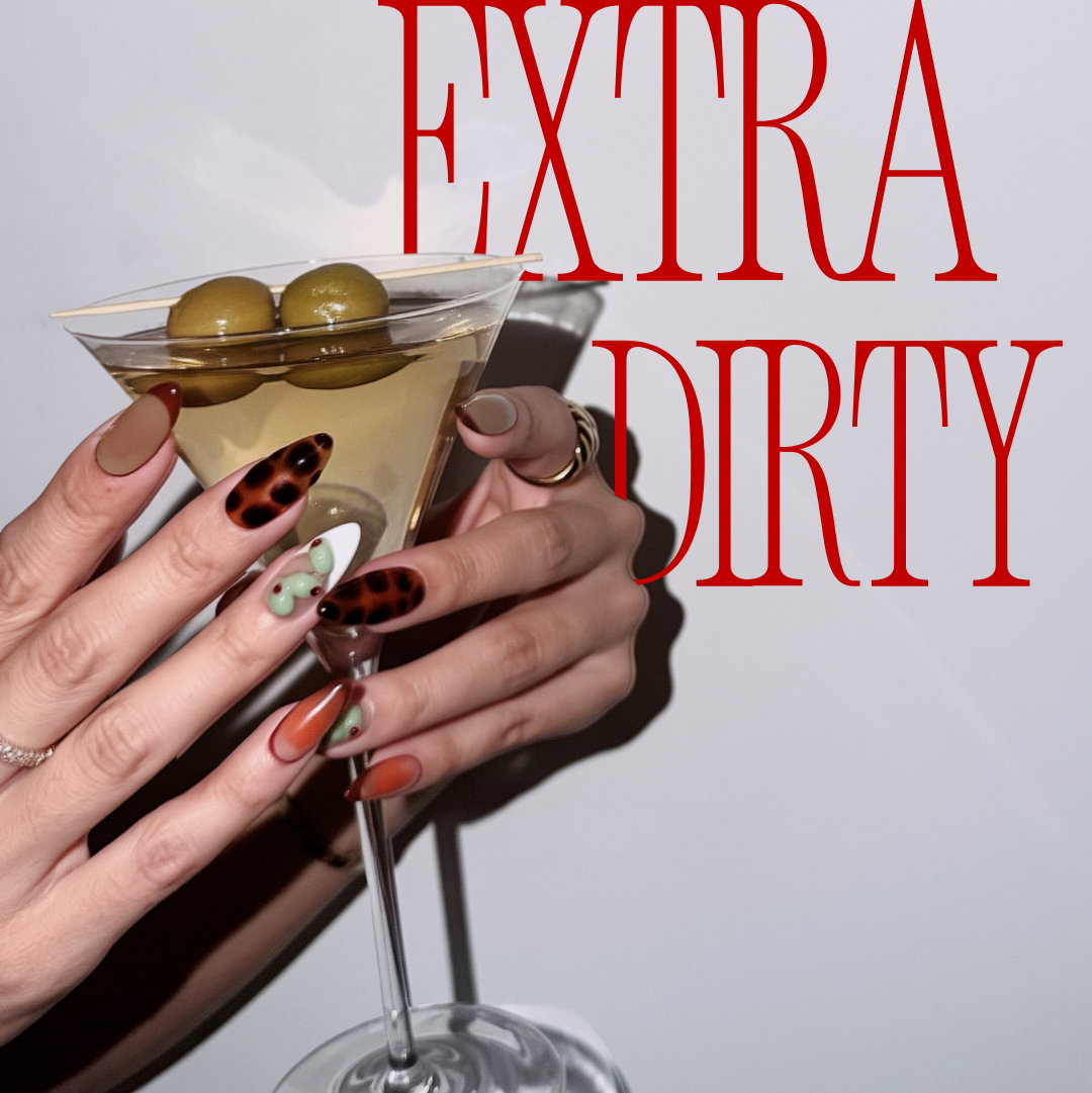 Hand holding a martini glass with olives, text 'Extra Dirty' in red, on a light background.